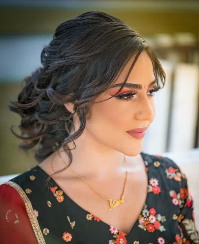 Roko applying lipstick to bride.